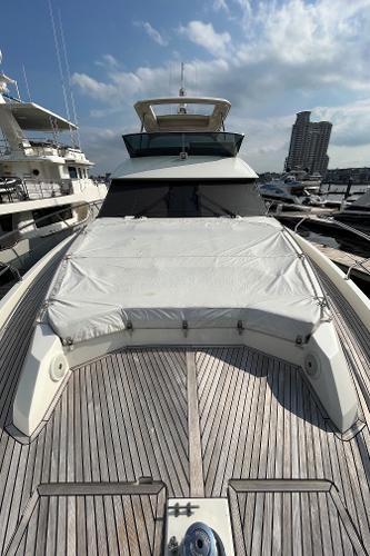 Slide: The Image of Luxury 2017 Prestige 63 yacht docked, showcasing sleek design and spacious deck. - 17