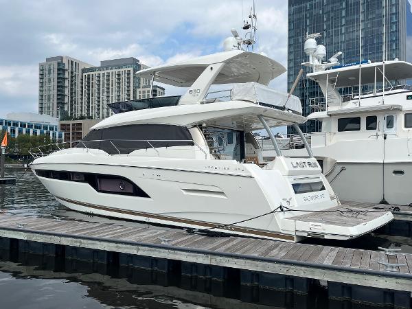 Slide: The Image of Luxury 2017 Prestige 63 yacht docked in urban marina setting. - 2