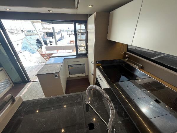 Slide: The Image of Luxurious kitchen interior of 2017 Prestige 63 yacht with modern appliances and marina view. - 20