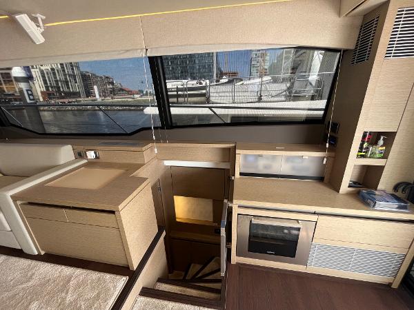 Slide: The Image of Interior of 2017 Prestige 63 yacht with modern kitchen and large windows. - 21