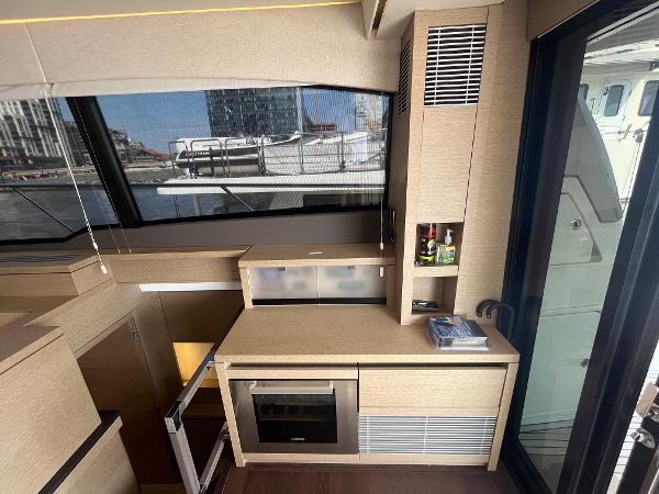 Slide: The Image of Modern kitchen area in a 2017 Prestige 63 yacht with sleek cabinetry and appliances. - 22