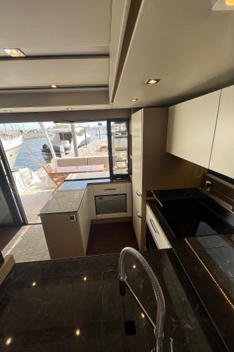 Slide: The Image of Modern kitchen interior on a 2017 Prestige 63 yacht, featuring sleek design and waterfront view. - 23