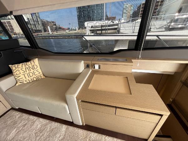 Slide: The Image of Luxurious interior of 2017 Prestige 63 yacht with beige seating and waterfront view. - 24