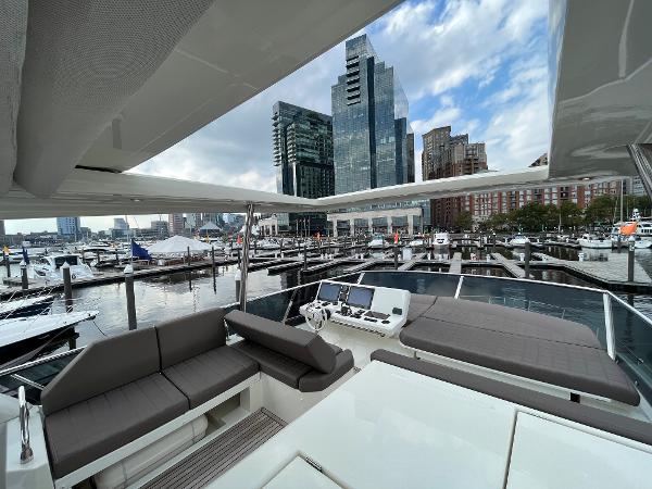 Slide: The Image of Luxurious 2017 Prestige 63 yacht docked in a modern marina with city skyline views. - 25