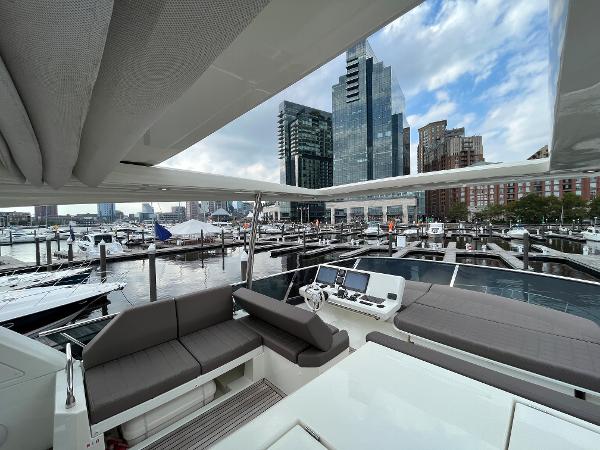 Slide: The Image of Luxurious 2017 Prestige 63 yacht docked in a modern marina with city skyline views. - 26