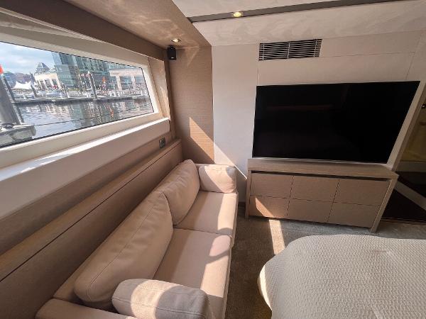 Slide: The Image of Luxurious interior of 2017 Prestige 63 yacht with sofa and large window view. - 30