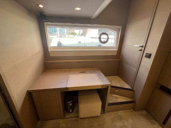 Slide: The Image of Luxurious interior of a 2017 Prestige 63 yacht with modern furnishings and window view. - 31