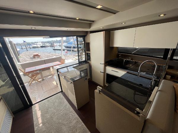 Slide: The Image of Luxurious 2017 Prestige 63 yacht interior with modern kitchen and marina view. - 40