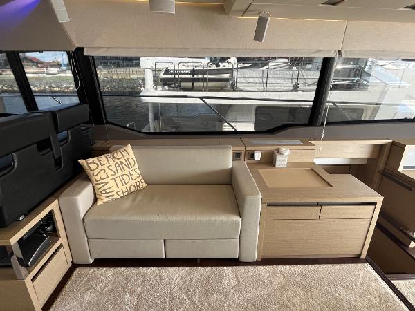 Slide: The Image of Luxurious interior of a 2017 Prestige 63 yacht with beige sofa and nautical-themed pillow. - 43