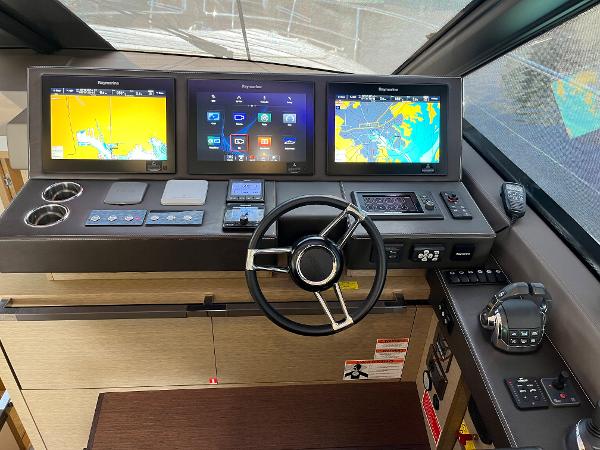 Slide: The Image of Helm of 2017 Prestige 63 yacht with advanced navigation displays and controls. - 46