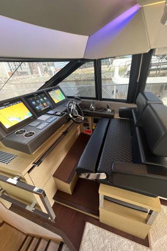 Slide: The Image of Luxurious 2017 Prestige 63 yacht helm with modern navigation systems and plush seating. - 49