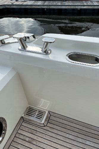 Slide: The Image of 2017 Prestige 63 yacht deck with sleek chrome fittings and wooden flooring. - 7