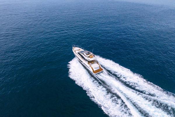 Slide: The Image of 2025 Princess S65 yacht cruising on open sea, aerial view. - 1