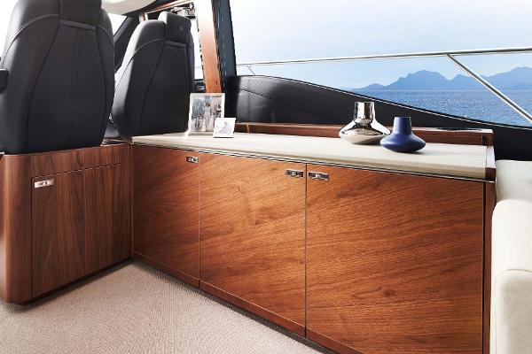 Slide: The Image of Luxurious interior of 2025 Princess S65 yacht with elegant wood cabinetry and scenic ocean view. - 10