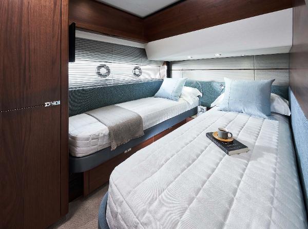 Slide: The Image of Luxurious 2025 Princess S65 yacht cabin with twin beds and elegant decor. - 19
