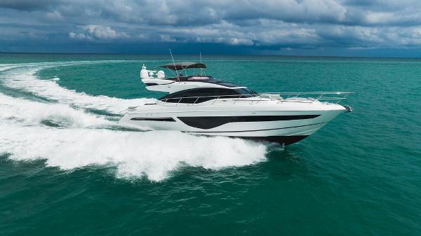 Slide: The Image of Luxurious 2022 Princess S66 yacht cruising on turquoise ocean under cloudy skies. - 0