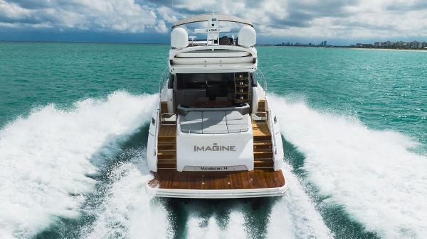 Slide: The Image of 2022 Princess S66 yacht cruising on turquoise waters, rear view. - 13