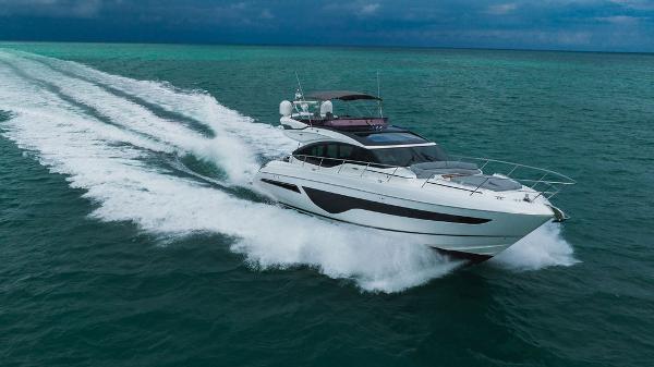 Slide: The Image of 2022 Princess S66 yacht cruising on open sea under cloudy skies. - 18