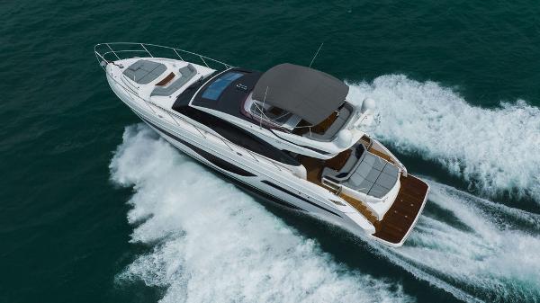 Slide: The Image of 2022 Princess S66 yacht cruising on open water, aerial view. - 19