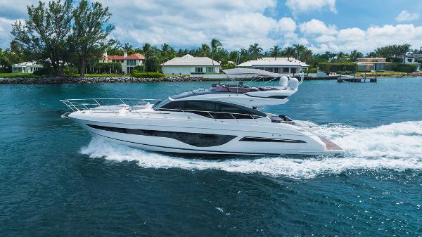 Slide: The Image of Luxury 2022 Princess S66 yacht cruising on a serene waterway. - 2