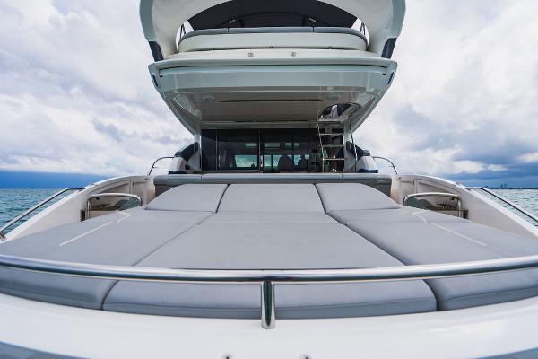 Slide: The Image of 2022 Princess S66 yacht with spacious deck, sleek design, and ocean backdrop. - 39