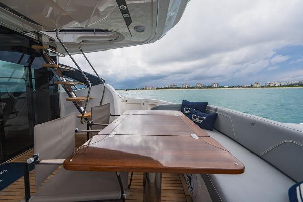 Slide: The Image of Luxury yacht Princess S66 deck with wooden table, chairs, and ocean view, 2022 model. - 43