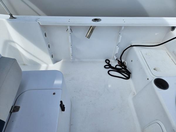 Slide: The Image of 2003 Pro-Line 20 Sport boat interior with seating and storage compartments. - 2