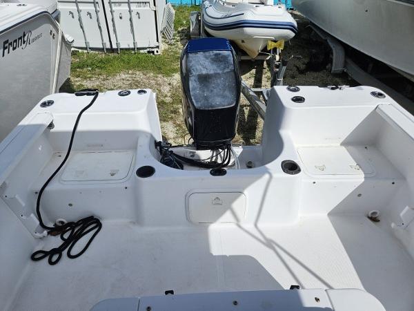 Slide: The Image of 2003 Pro-Line 20 Sport boat with outboard motor, docked on land. - 3