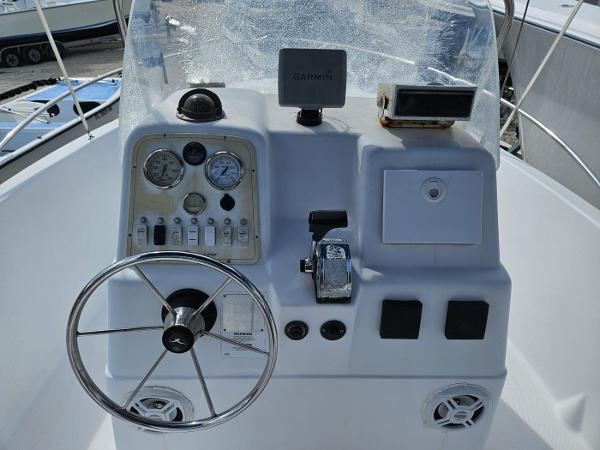 Slide: The Image of 2003 Pro-Line 20 Sport boat dashboard with steering wheel and navigation instruments. - 5