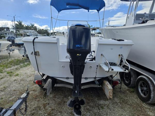 Slide: The Image of 2003 Pro-Line 20 Sport boat with outboard motor and blue canopy. - 7