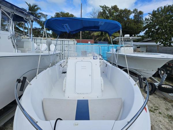 Slide: The Image of 2003 Pro-Line 20 Sport boat with blue canopy in a marina. - 8