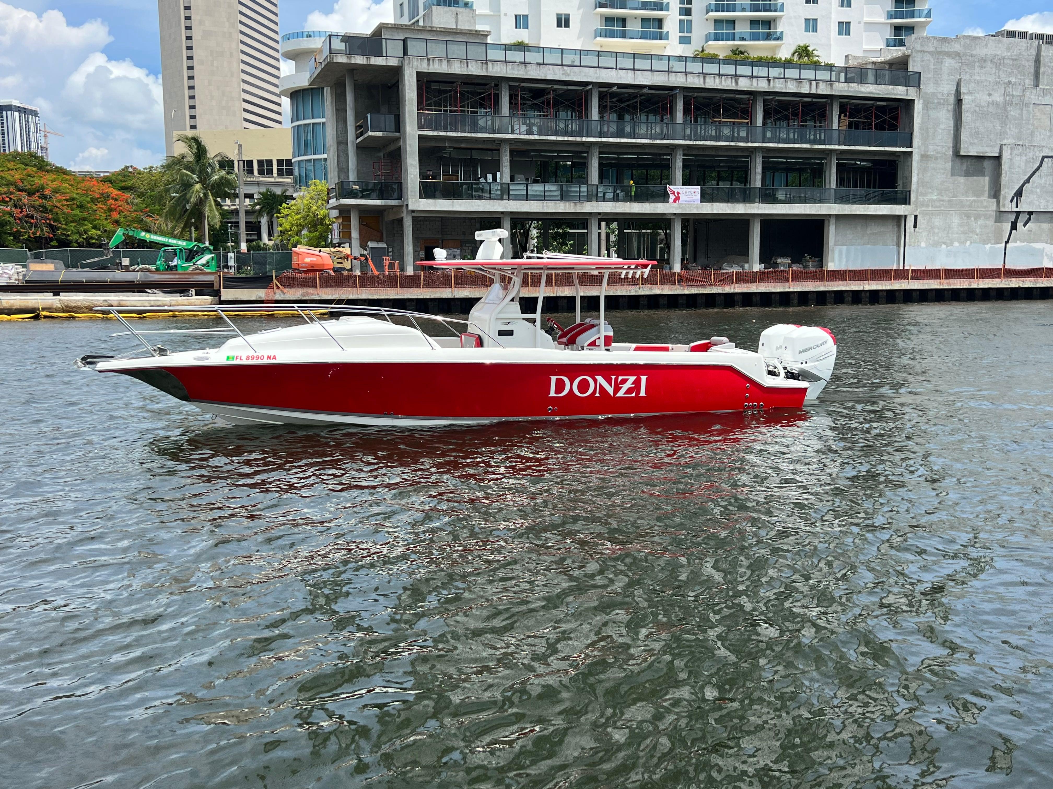 Slide: The Image of Red 2016 Pro-Line 3400 Cuddy boat docked near urban waterfront. - 0