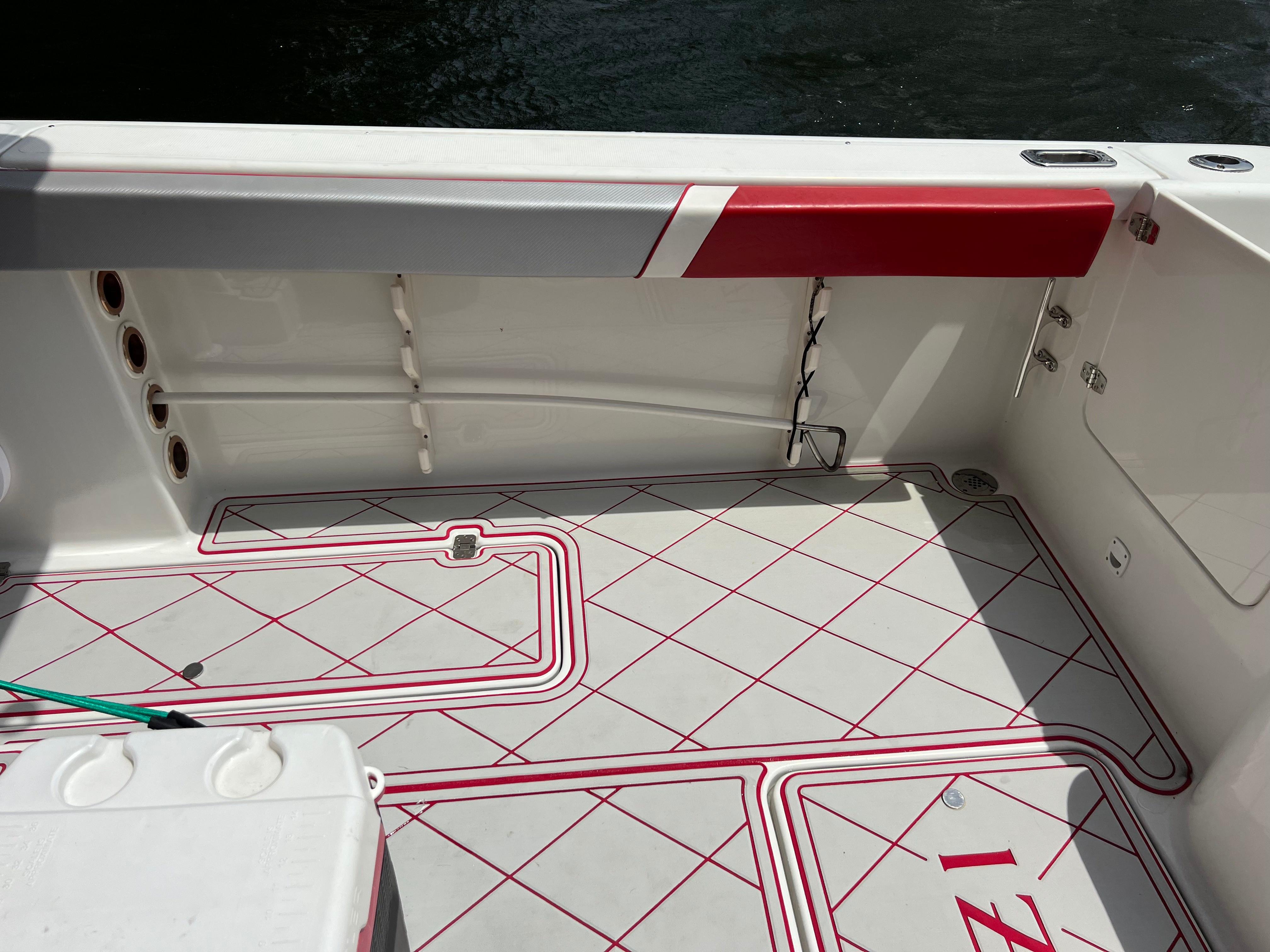 Slide: The Image of 2016 Pro-Line 3400 Cuddy boat interior with red and white flooring. - 11