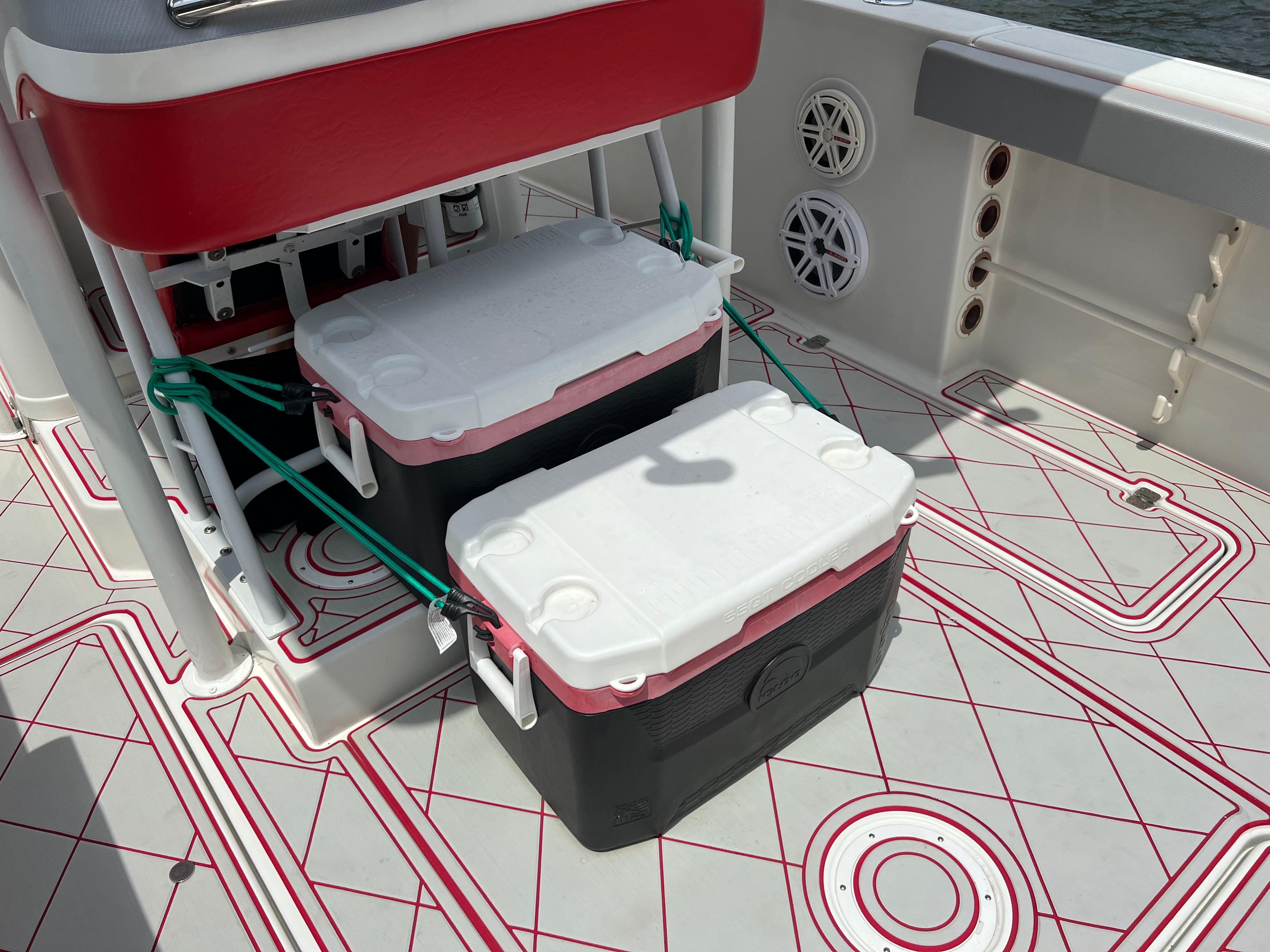 Slide: The Image of Pro-Line 3400 Cuddy 2016 boat deck with coolers and red accents. - 13