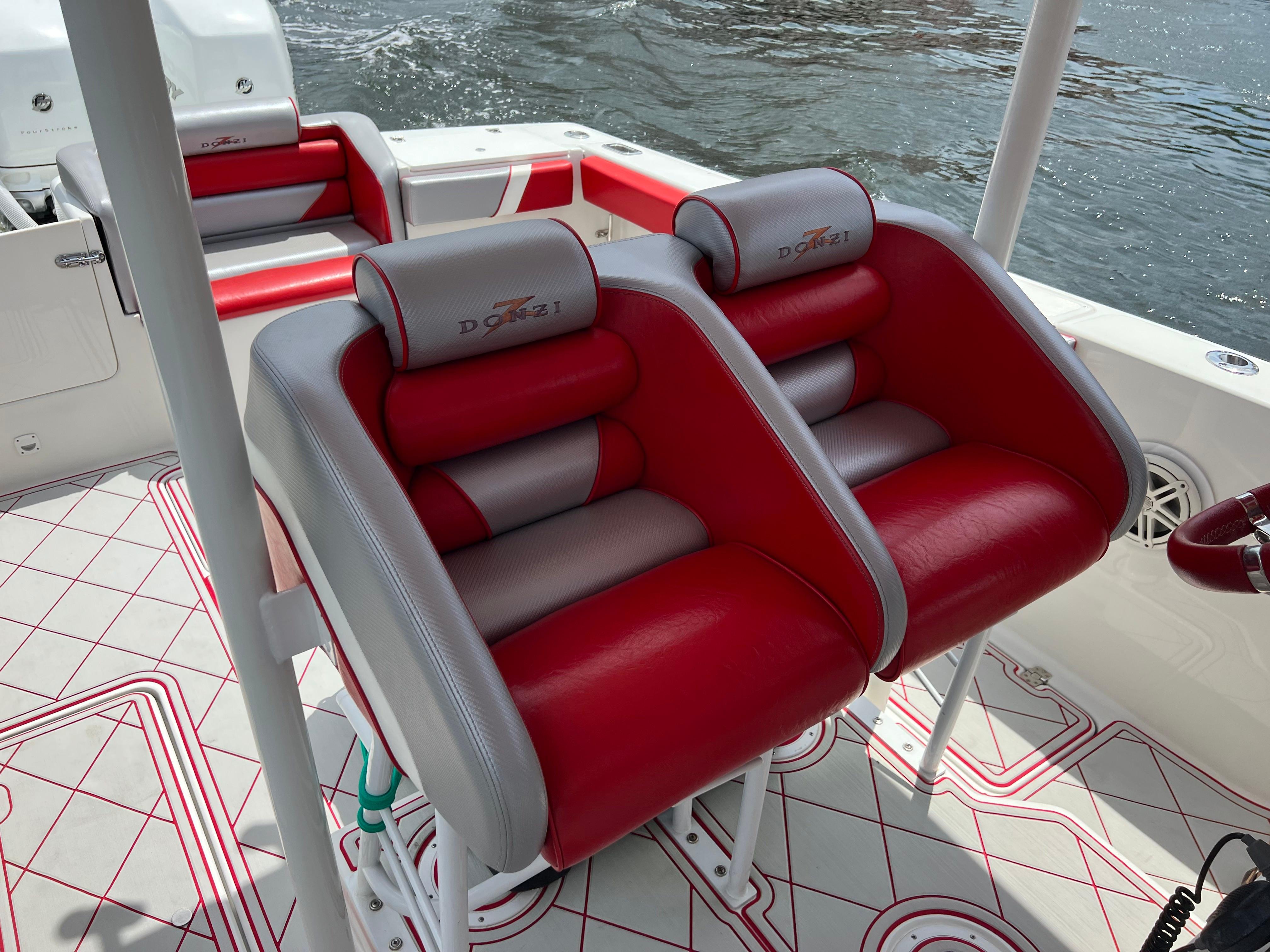 Slide: The Image of Red and gray seats on a 2016 Pro-Line 3400 Cuddy boat. - 14