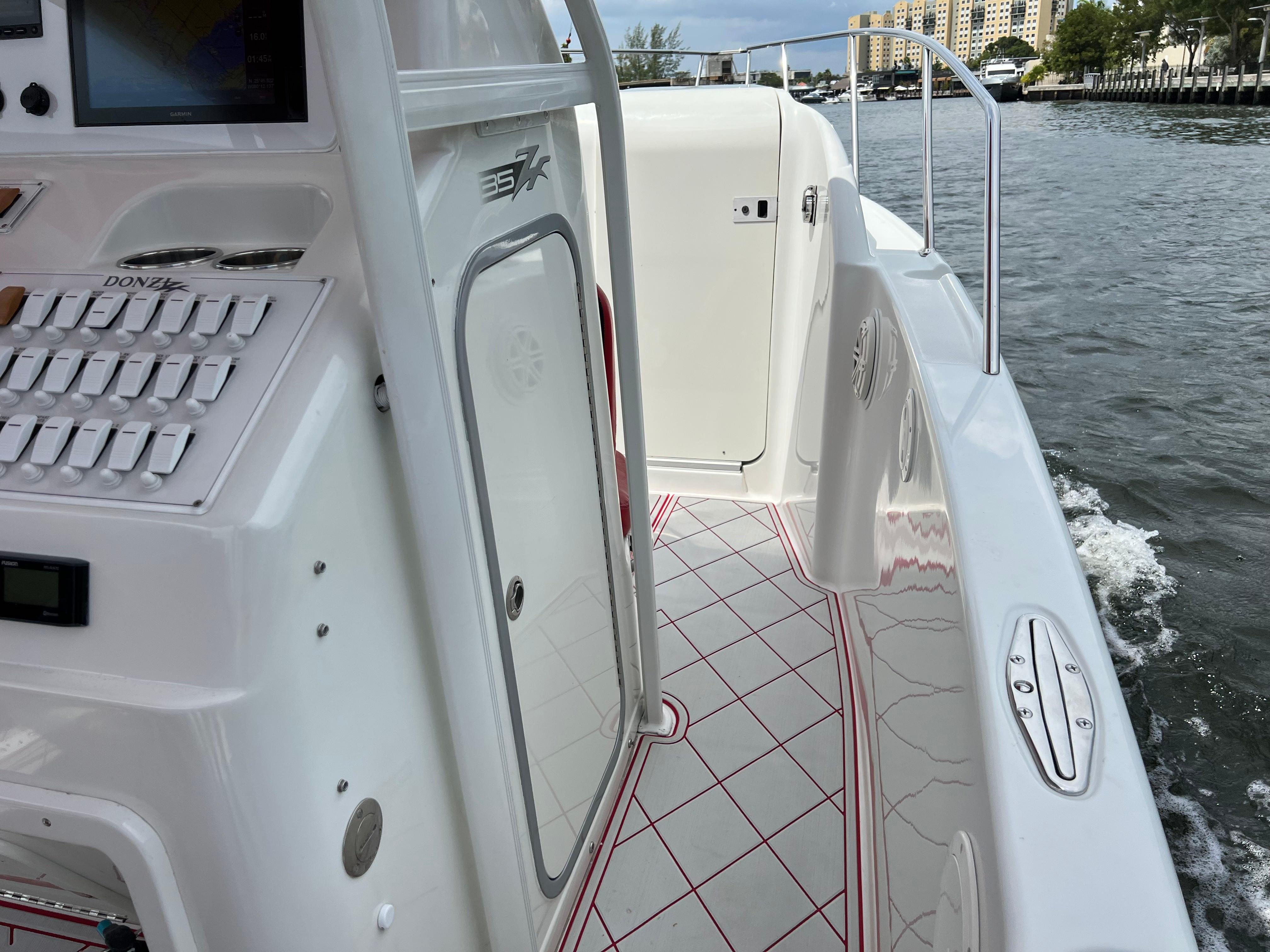 Slide: The Image of 2016 Pro-Line 3400 Cuddy boat interior with control panel and water view. - 15