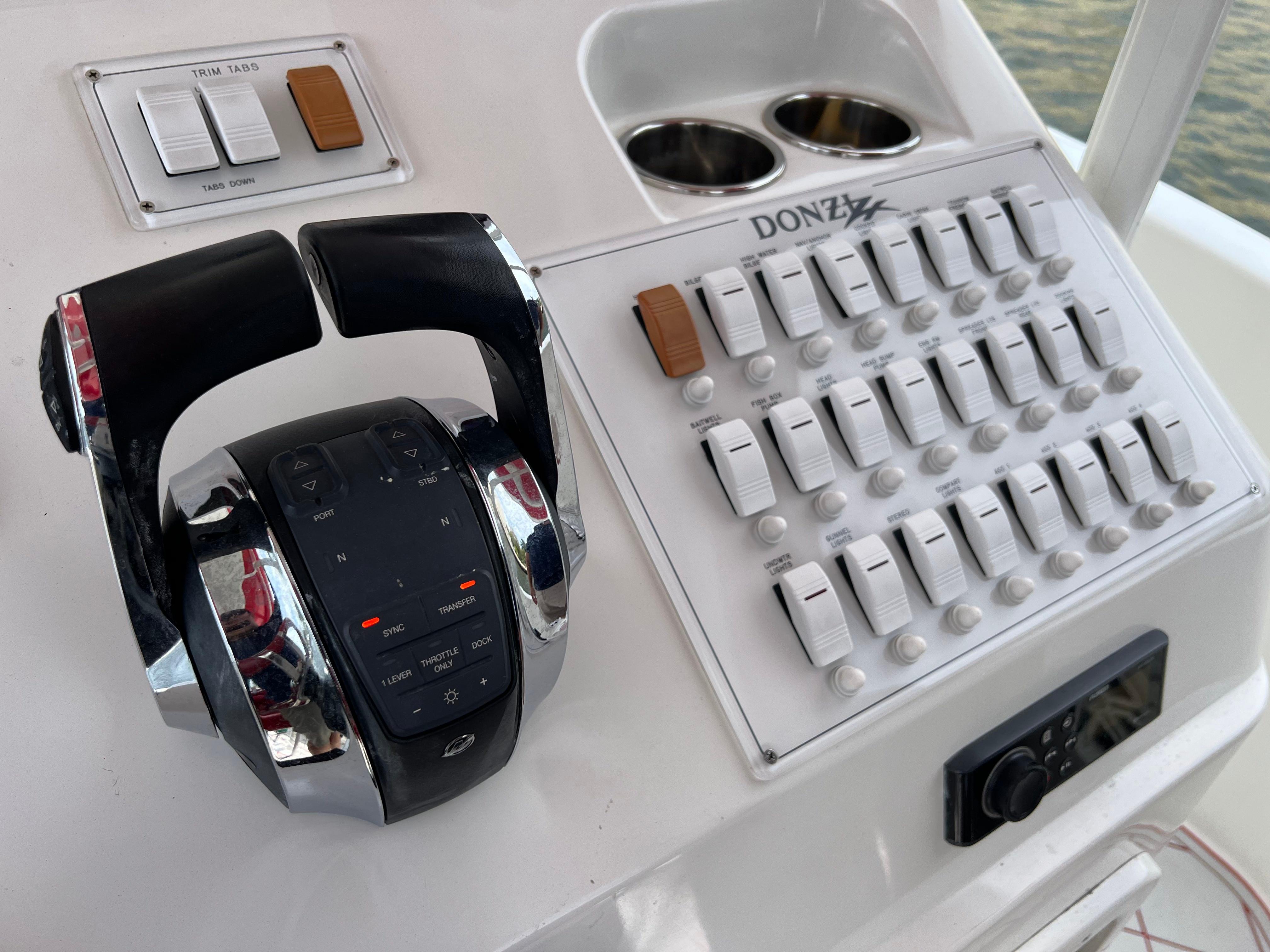 Slide: The Image of Control panel of a 2016 Pro-Line 3400 Cuddy boat with throttle and switches. - 21