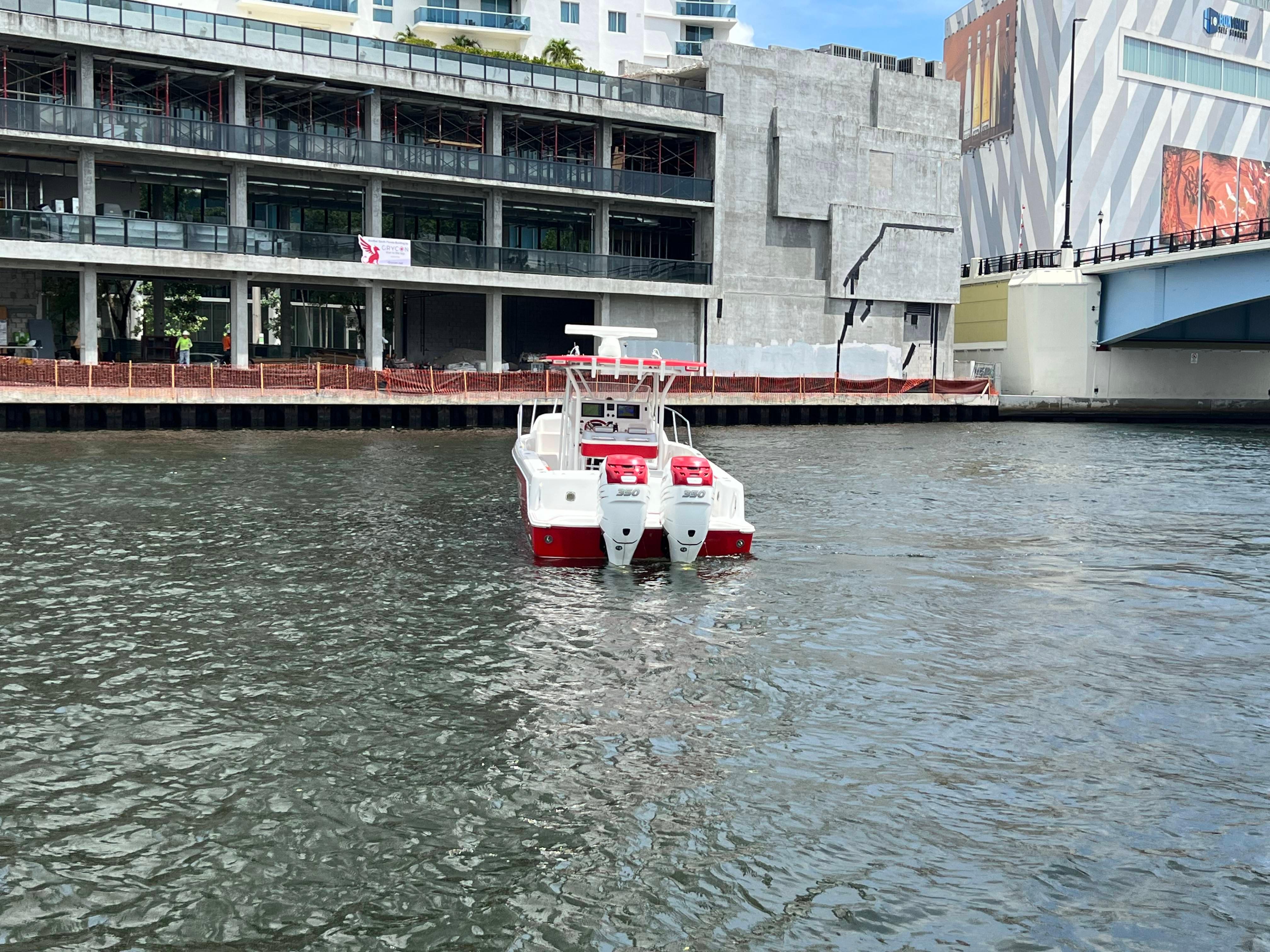 Slide: The Image of Pro-Line 3400 Cuddy 2016 boat with twin engines on urban waterfront. - 4