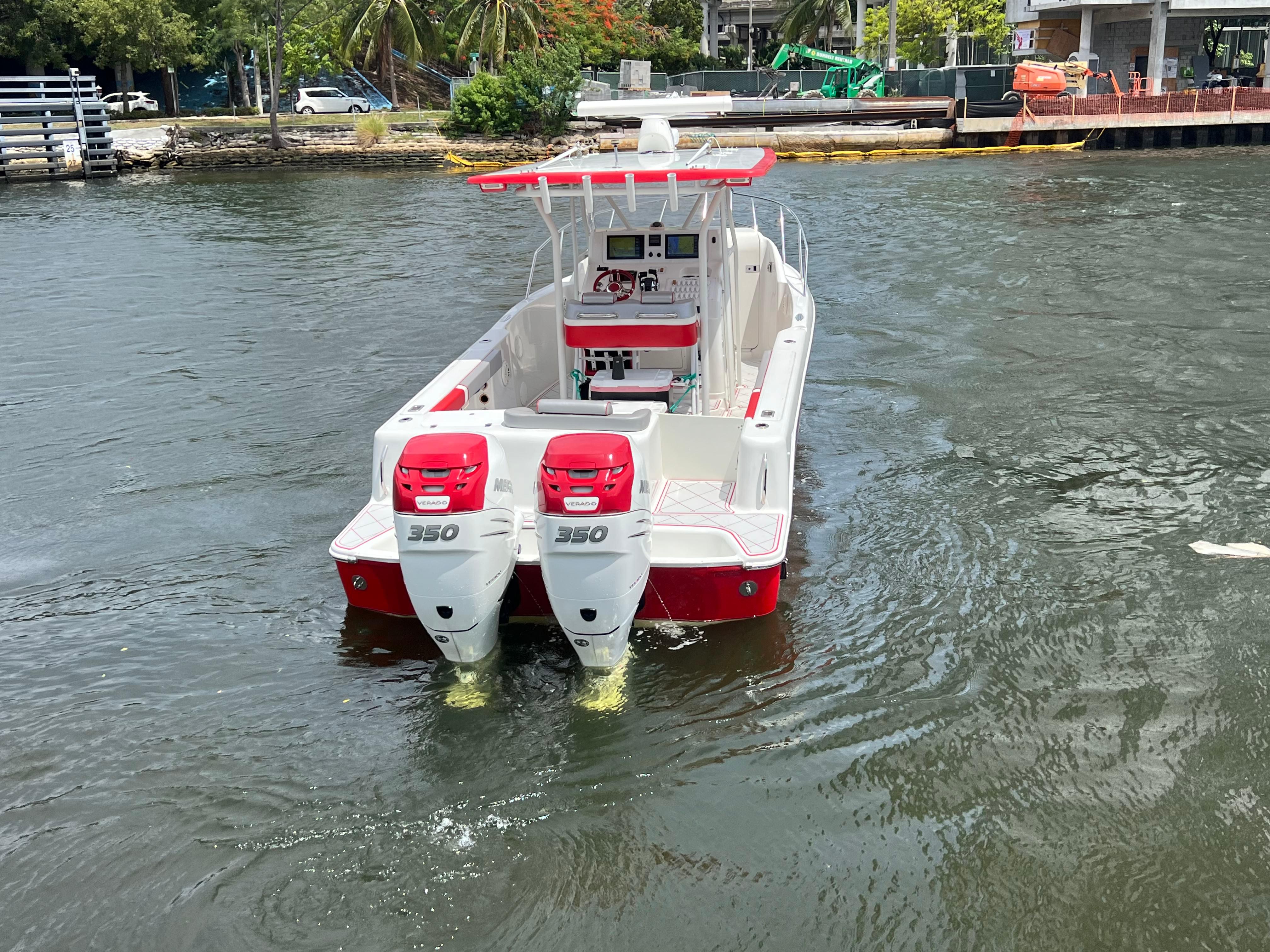 Slide: The Image of 2016 Pro-Line 3400 Cuddy boat with twin 350 engines on the water. - 6