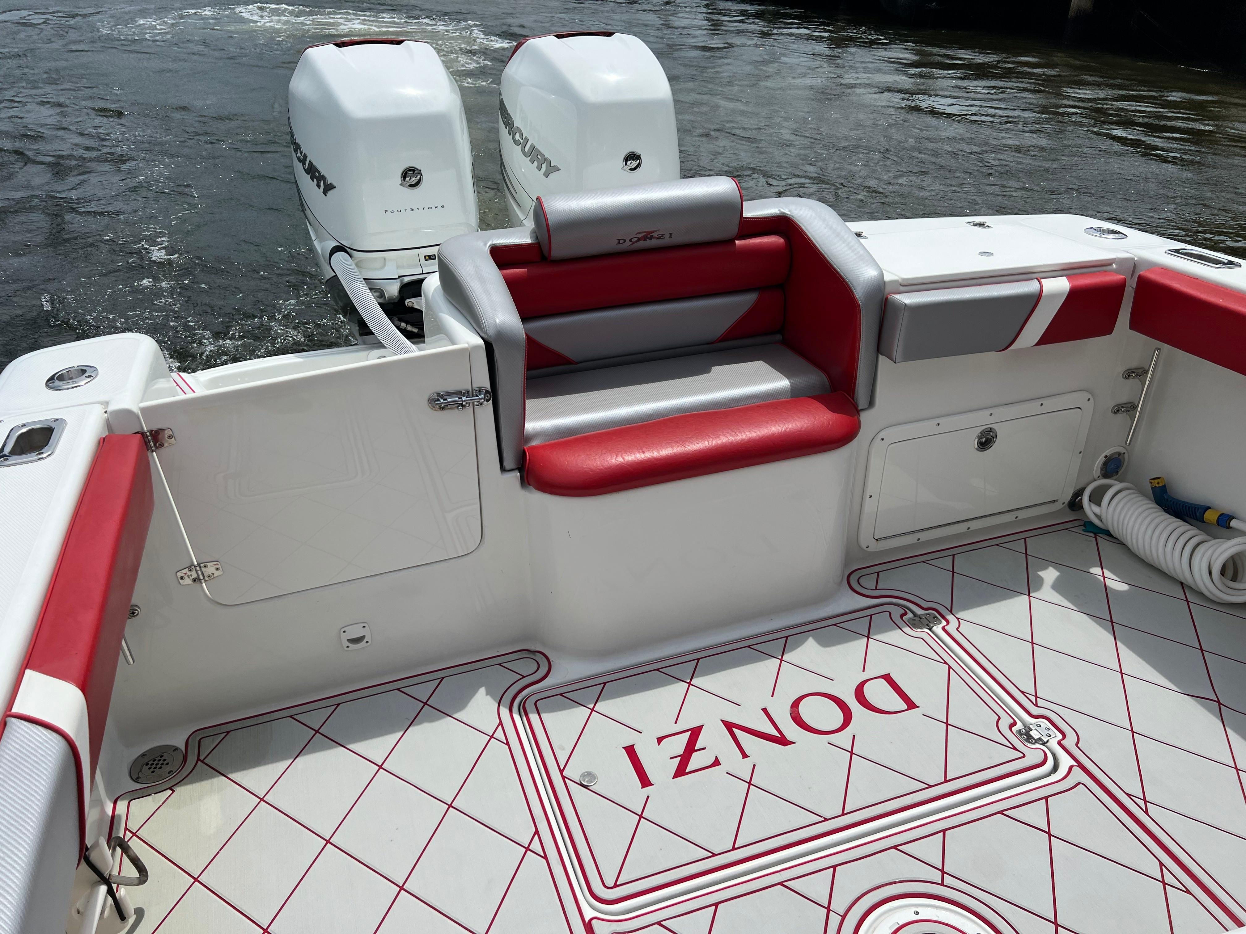 Slide: The Image of 2016 Pro-Line 3400 Cuddy boat with twin Mercury outboard engines and custom red and white seating. - 9