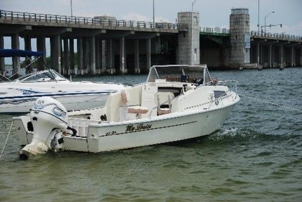 Slide: The Image of 1979 Pro-Line Pro-20 Cuddy boat anchored near a bridge. - 0