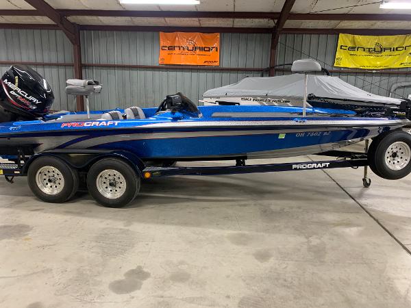 Slide: The Image of 1998 ProCraft 200 Bass boat, blue, on trailer in garage. - 0