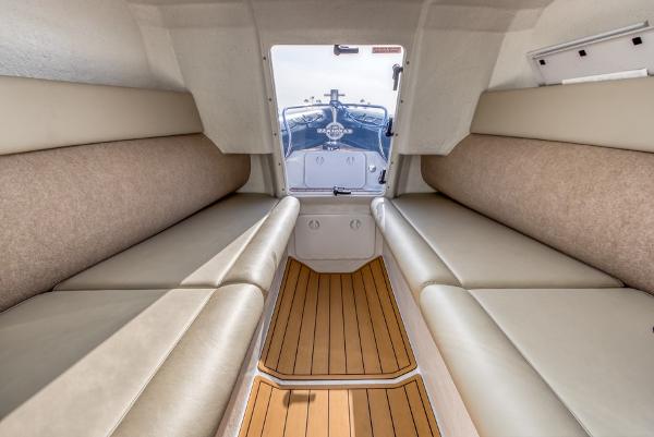 Slide: The Image of Interior of 2020 Protector 330 Targa boat with beige seating and wooden flooring. - 2