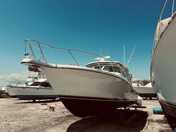 Slide: The Image of 2002 Pursuit 3800 Express boat on dry dock under clear blue sky. - 13