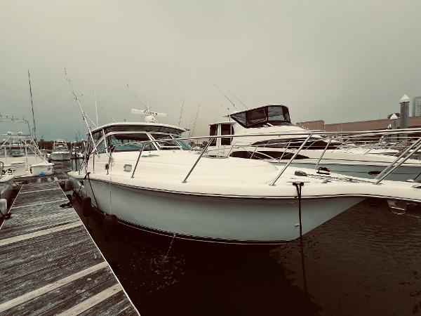 Slide: The Image of 2002 Pursuit 3800 Express boat docked at marina. - 2