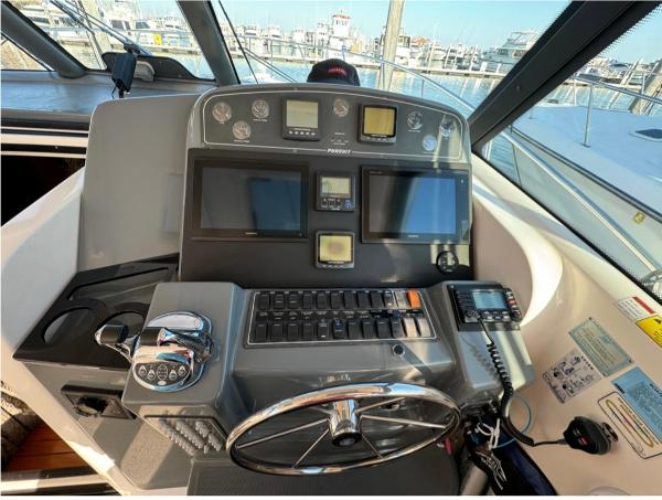 Slide: The Image of Helm of a 2002 Pursuit 3800 Express boat with navigation and control systems. - 5