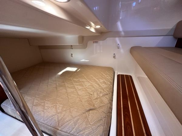 Slide: The Image of 2012 Pursuit OS 375 Offshore cabin interior with bed and seating area. - 19