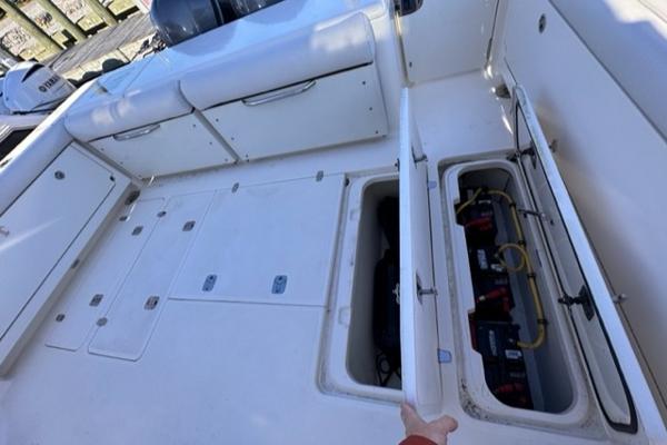 Slide: The Image of 2012 Pursuit OS 375 Offshore boat deck with open storage compartments. - 25