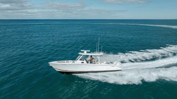 Slide: The Image of 2022 Pursuit S 328 boat cruising on open water. - 0