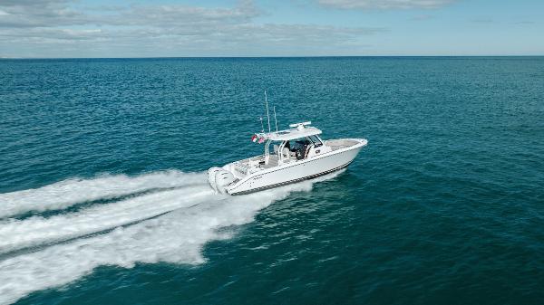 Slide: The Image of 2022 Pursuit S 328 boat cruising on open water. - 21